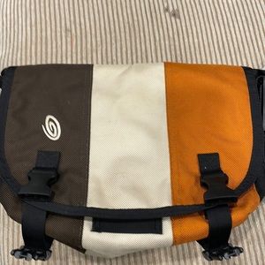 I have a small timbuk2 shoulder bag. It is brown,orange,black and tan.